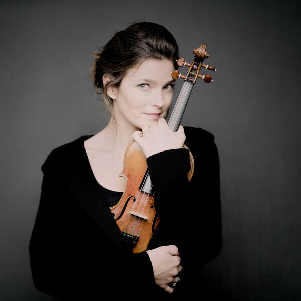 Portrait der Violinistin Janine Jansen vor dunklem Hintergrund mit Geige